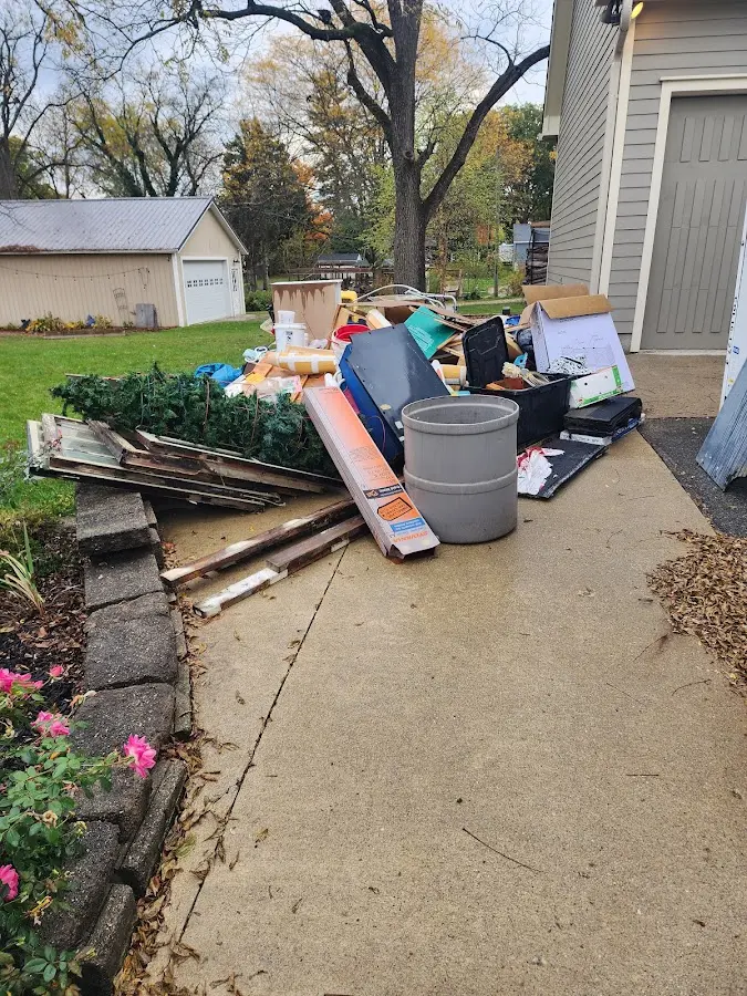 Dumpster being loaded with debris for 12 Yard Dumpster Rental in North Hempstead